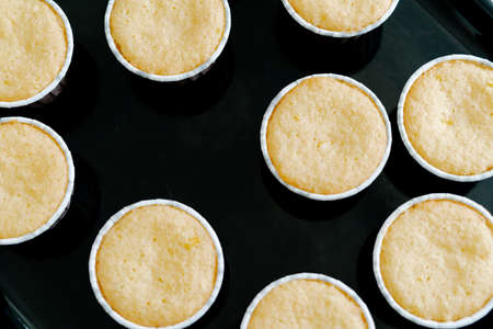 freshly baked cupcakes on a black protvin background.Food for breakfast. Freshly baked cupcakes for dessert. Foodies and cuisine.の写真素材