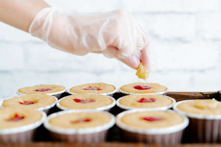 freshly baked cupcakes with strawberry berry filling on a wooden tray.Food for breakfast. Freshly baked cupcakes for dessert.の写真素材