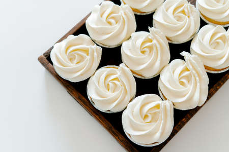 freshly baked cupcakes with strawberry-berry filling and white cream cheese on a wooden tray.Food for breakfast. Freshly baked cupcakes for dessert.の写真素材