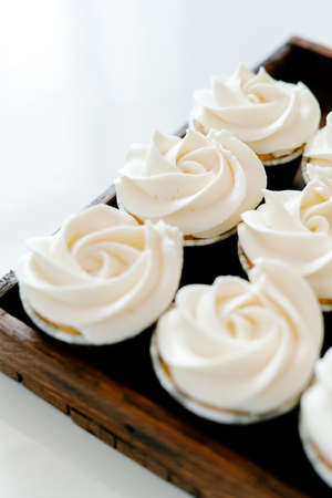 freshly baked cupcakes with strawberry-berry filling and white cream cheese on a wooden tray.Food for breakfast. Freshly baked cupcakes for dessert.の写真素材
