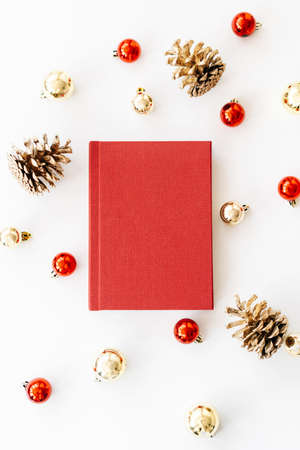 a red book on a white background with gifts, cones and Christmas toys. the concept of Christmas. High quality photoの写真素材
