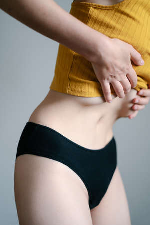 a young girl does breathing exercises for the body - pranayama, abdominal vacuum, internal organ massageの写真素材