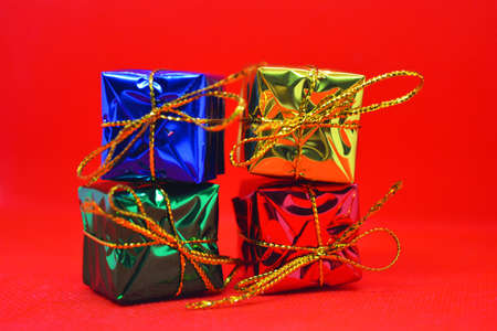 Bright, colorful, shiny packaging, boxes with festive and New Year's gifts tied with gold threads...