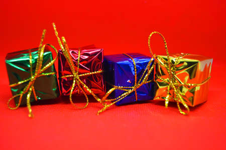 Bright, colorful, shiny packaging, boxes with festive and New Year's gifts tied with gold threads...