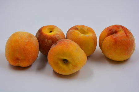 Delicious ripe, juicy red yellow peaches are located on a white background.の写真素材