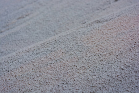 White large snowflakes dotted over the entire surface of a wooden board in winter, a beautiful winter natural background.の写真素材