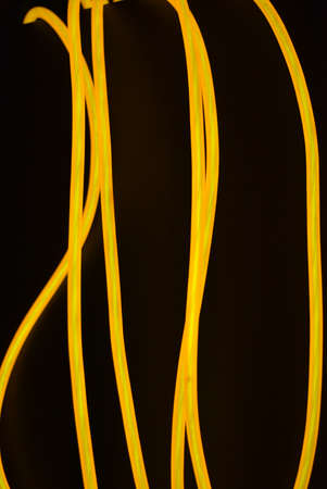 Bright orange luminous wire, twisted light wire, cable. Different shapes and images of lectroluminescent wires with different twists, juicy el wire.の写真素材