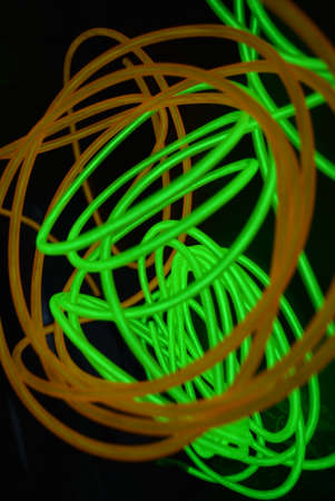 Bright luminous yellow and green, lime neon wires in different formats and layouts. An...