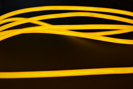 Bright orange luminous wire, twisted light wire, cable. Different shapes and images of lectroluminescent wires with different twists, juicy el wire.の写真素材