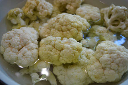 Fresh white cauliflower in water, healthy wholesome food and vegetables.の写真素材