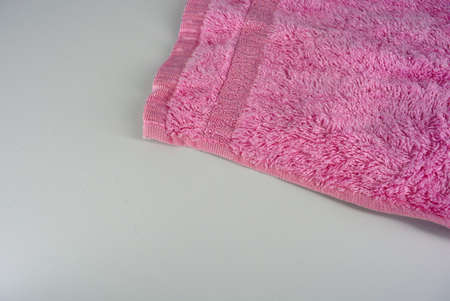 Soft pink facial towel made of bamboo threads and located on a white background.