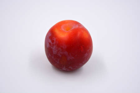 Delicious useful fruits, red, cherry ripe plums located on a white background.の写真素材
