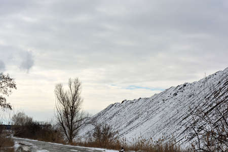 Bright, colorful high mountains, peaks, steep hills are located along the road and covered with...
