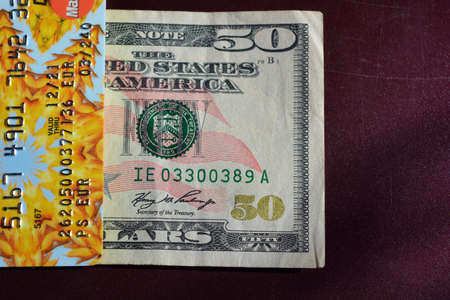 American money, one bill USA, 50 fifty dollars with a Ukrainian bank credit card are located on a...