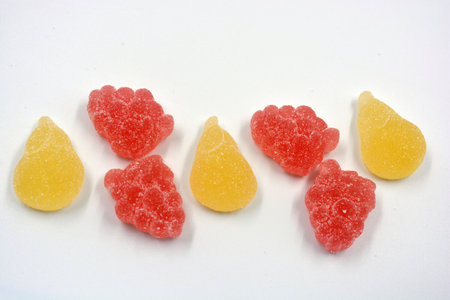 Beautiful and colorful sweet jelly candies made from natural juice in the form of natural fruits: pears, apples, raspberries, orange slices, watermelon and lemon.の写真素材