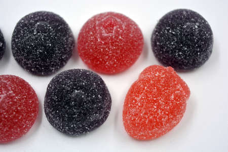 Bright cherry, red, purple, pink, delicious candies in the form of fruits, currants, grapes, raspberries, blueberries, strawberries.の写真素材