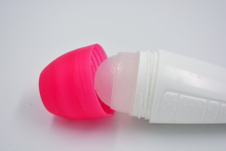 An interesting plastic packaging from women's roll-on deodorant with a pink plastic lid is located on a white background.の写真素材