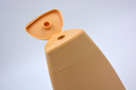Beautiful brown plastic bottle, packaging from shampoo, body care cream is located on a white background. Liquid soap dispenser on white background. Shallow dof.の写真素材