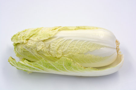 A large cabbage, Peking cabbage located on a white background. Healthy food, healthy food, fresh vegetables. Fresh chinese cabbage, closeup of photo.の写真素材