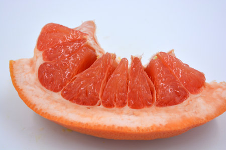 Fresh fruit, delicious and healthy yellow red ripe grapefruit lies cut with a red core on a white background. Grapefruit cut in half on a white background. close up.の写真素材