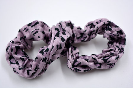 An interesting women's fabric elastic band made of purple with black dots of hair fabric. Lilac...