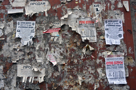 Advertising, old type of ads, paper ads that people pasted on the wall in the city of Dnipro, ukraine.の写真素材