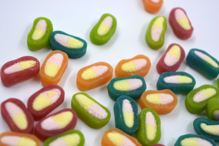 Interesting and unusual, colored caramel candies, sweets with a white center. Colorful jelly candies on a white background, close-upの写真素材