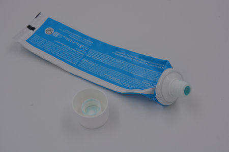 A white and blue tube of toothpaste on a white background. Medicine, medicines, dental and oral care...