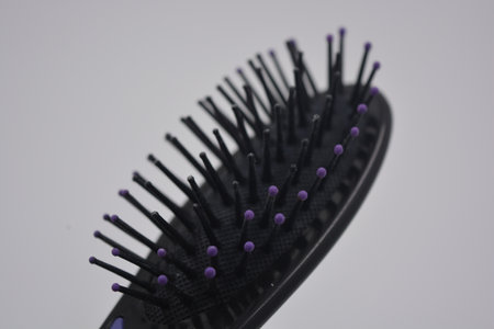 Hairbrush on a white background. Close-up. Selective focus. Women's accessories and things, black...