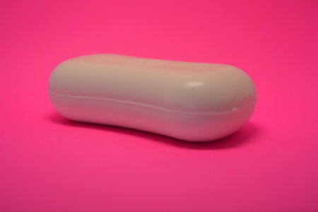 White soap on a pink background. 3d rendering, 3d illustration. Clothes, personal hygiene products, new white hand soap placed on pink background.の写真素材