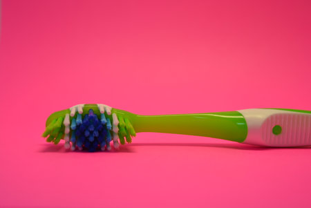 Toothbrush with toothpaste on a pink background. Oral hygiene. Things, personal hygiene products, new toothbrush placed on pink background.の写真素材