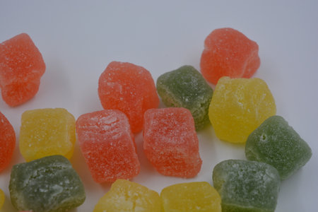 Colorful fruit jelly candies on a white background, close up. Beautiful, small pieces of gummy confections. Delicious, natural, fruity marmalade in green, yellow, red.の写真素材