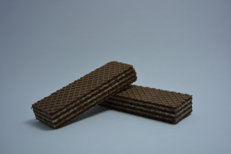 Chocolate wafers on white background. Close-up. On white paper sweet chocolate wafers with white coconut filling.の写真素材