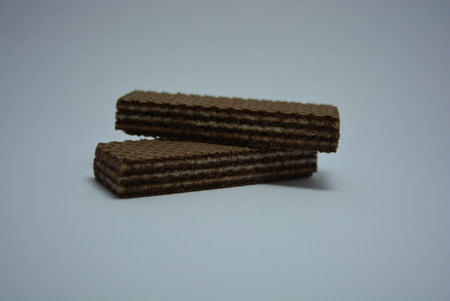 Chocolate wafers isolated on white background. Selective focus. On white paper sweet chocolate wafers with white coconut filling.の写真素材