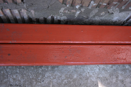 Profiled iron pipes primed, painted with red paint.