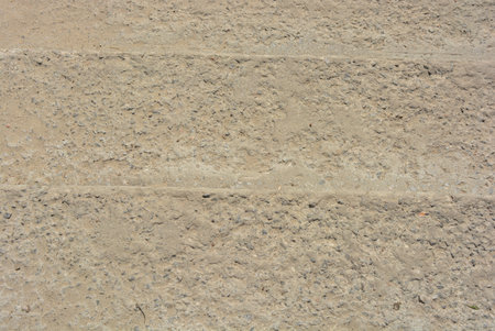 Yellow concrete background of gravel and sand, concrete steps
