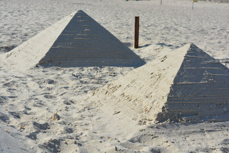 Pyramid of sand on the beach, close-up of photo. Made two pyramids of white sand and sea shells on the Black Sea beach during the day.の写真素材