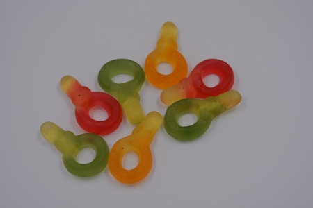 Colorful gummy bear candies isolated on the white background. Unusual and non-standard, small jelly...