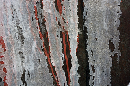 The texture of the old wall is covered with red and black paint. Old building materials, rusty metal...