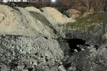 Abandoned mine in the middle of the forest in winter. An industrial area, hills and mountains of...