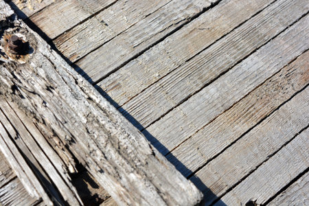 Old wooden planks on the beach. Abstract background and texture for design. Construction and repair work, old thin boards are knocked into one wooden background.の写真素材