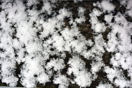 White snow on the old wooden background, top view, close-up. Winter, winter weather, beautiful white...