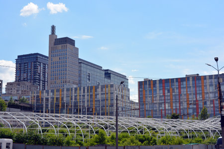 View of the modern skyscrapers. Unusual bright real estate, beautiful multi-storey colorful buildings, pleasant architecture, green trees on the embankment.の写真素材