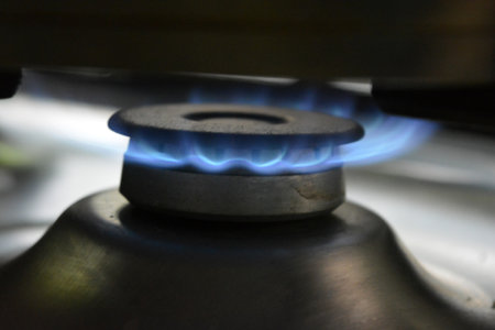 Gas burner in the kitchen close-up. The concept of cooking. Food, cooking, household gas, fire from a household, gray burner.の写真素材