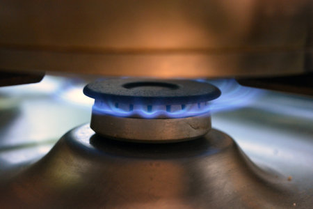 Gas burner in the kitchen close-up. The concept of cooking. Food, cooking, household gas, fire from a household, gray burner.の写真素材