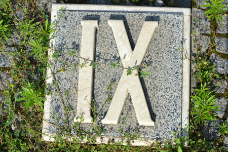 White inscriptions in gray granite of Roman numerals one, two, three, four, five, six, seven, eight, nine and ten.の写真素材