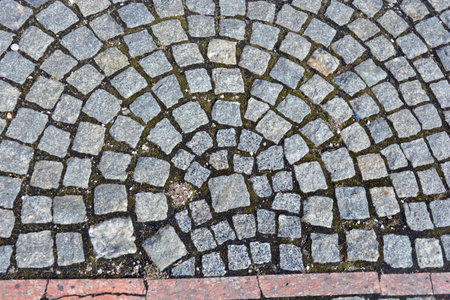 Cobblestone pavement background. Texture of cobblestone pavement. Beautiful stones, gray cobblestones, gray stones laid out textured on the ground, masonry with stones.の写真素材