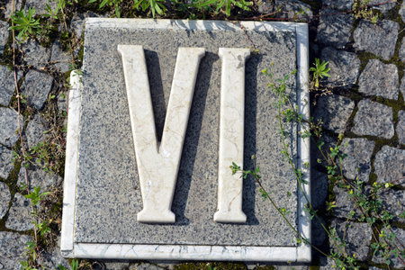 The name V is written on a stone plaque in the park. White inscriptions in gray granite of Roman numerals one, two, three, four, five, six, seven, eight, nine and ten.の写真素材