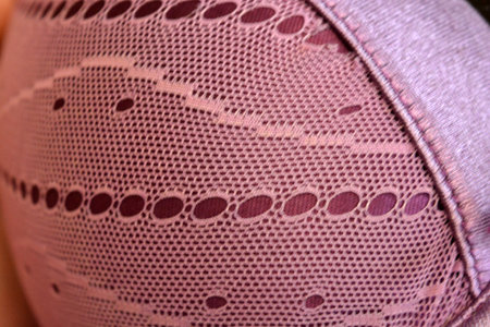 Close-up of pink fabric. Unusual materials, backgrounds, synthetic fabrics. Purple thin fabric mesh is located on purple glossy fabric.の写真素材