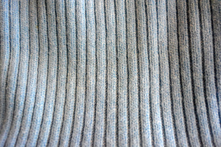 Close up of a knitted sweater. Knitted fabric.  Knitted products, women's woolen sweater  patterns,...